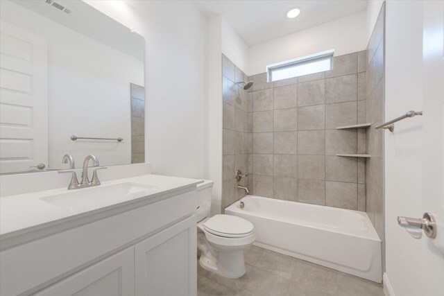 bathroom with visible vents, tile patterned flooring, shower / washtub combination, vanity, and toilet
