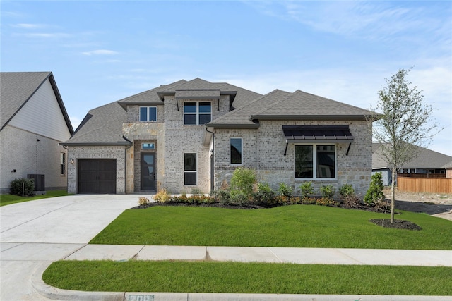 2206 Stratford Rd, Rockwall, TX 75087 - view of front of home featuring a garage, concrete driveway, brick siding, and roof with shingles