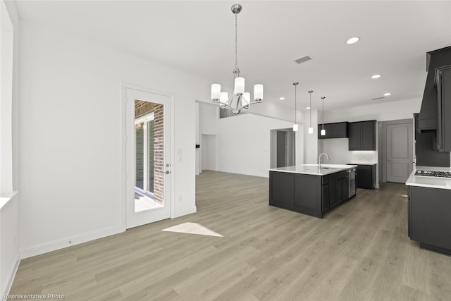 kitchen with light countertops, a chandelier, open floor plan, light wood-type flooring, and visible vents