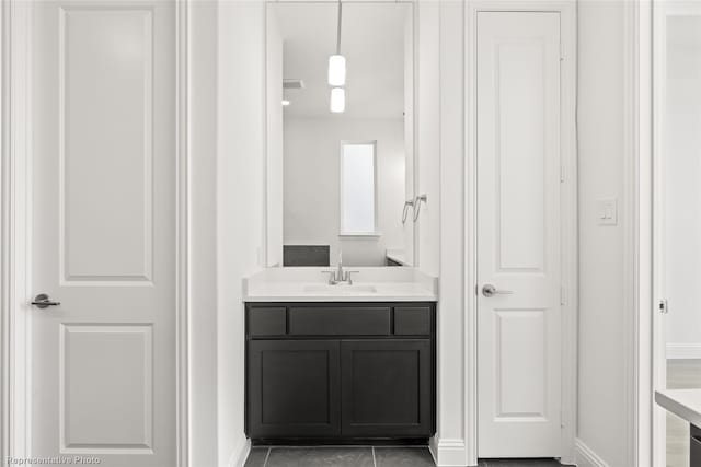 bathroom featuring baseboards and vanity