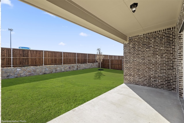 view of yard featuring a patio and a fenced backyard
