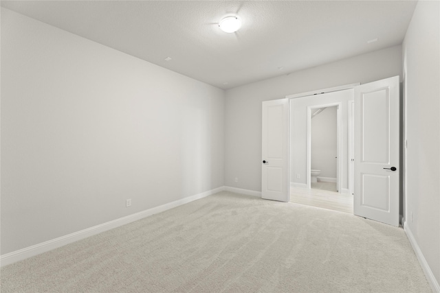 2206 Stratford Rd, Rockwall, TX 75087 - unfurnished bedroom with light colored carpet, baseboards, and ensuite bath