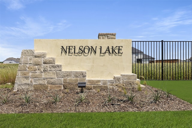 community sign featuring fence