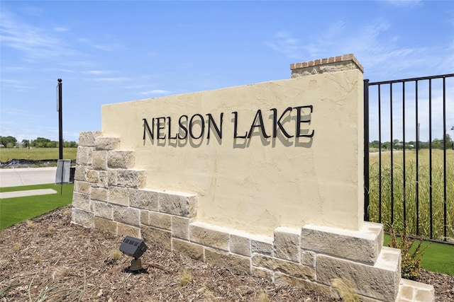 community sign featuring fence