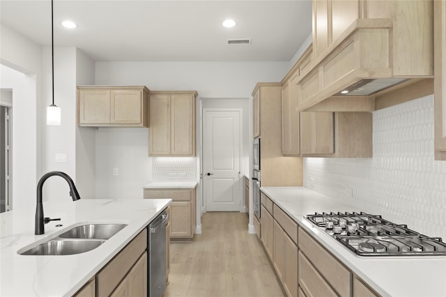 2206 Stratford Rd, Rockwall, TX 75087 - kitchen with light brown cabinetry, a sink, appliances with stainless steel finishes, light wood-type flooring, and decorative backsplash