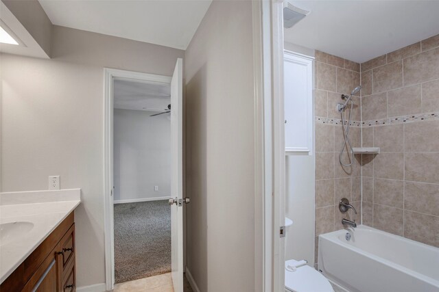 bathroom with vanity, shower / bathtub combination, toilet, a ceiling fan, and baseboards