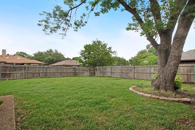 view of yard with a fenced backyard