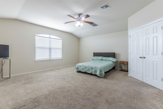 carpeted bedroom featuring a ceiling fan, visible vents, and vaulted ceiling