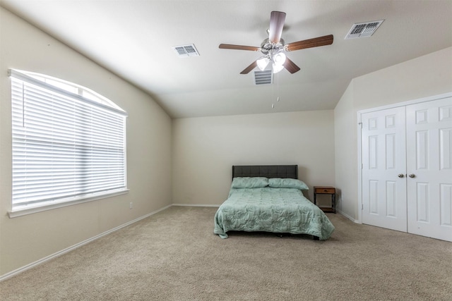 bedroom with lofted ceiling, carpet flooring, and visible vents