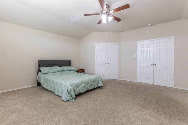 bedroom with carpet flooring, vaulted ceiling, and visible vents