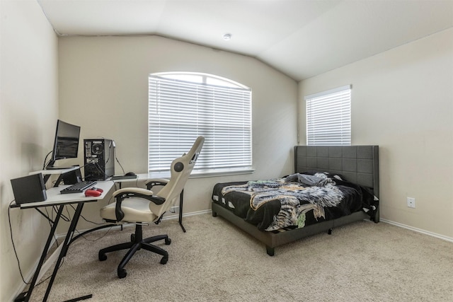 carpeted bedroom featuring baseboards and vaulted ceiling