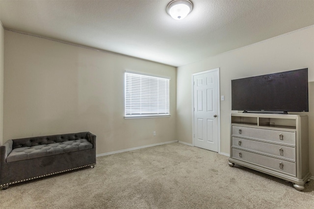 sitting room featuring baseboards and carpet