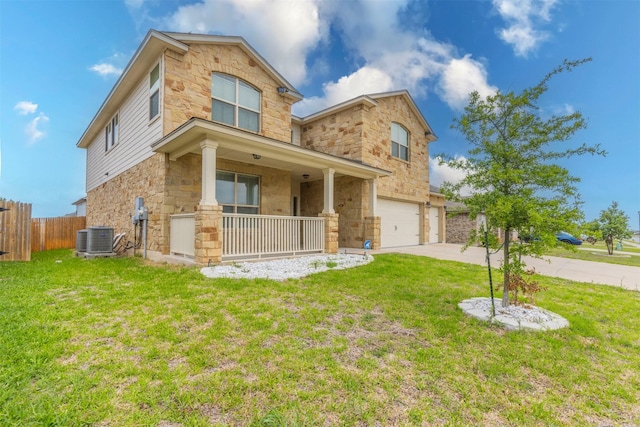traditional-style home with a front lawn, fence, covered porch, stone siding, and an attached garage