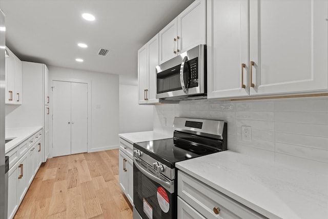 kitchen with appliances with stainless steel finishes, light wood-style flooring, tasteful backsplash, recessed lighting, and white cabinets