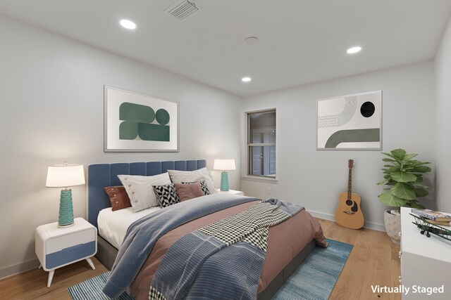 bedroom featuring light wood-type flooring, baseboards, and recessed lighting