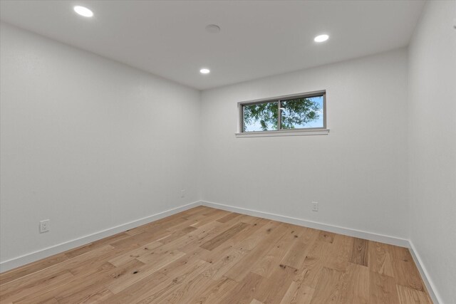 unfurnished room featuring baseboards, recessed lighting, and light wood-style flooring