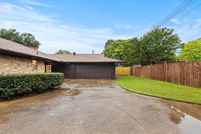 garage featuring concrete driveway