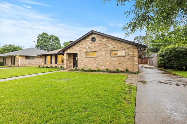 view of front of home featuring brick siding and driveway