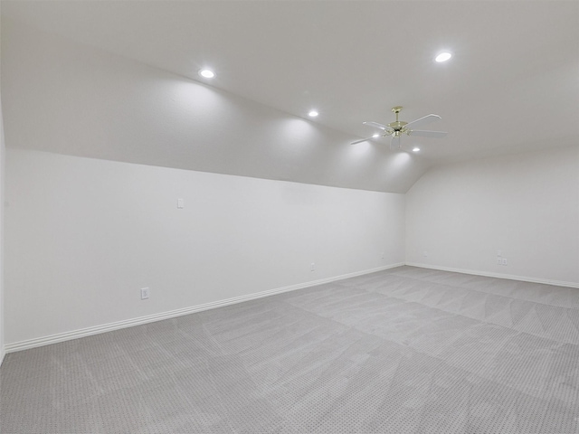 bonus room featuring baseboards, ceiling fan, light carpet, and lofted ceiling
