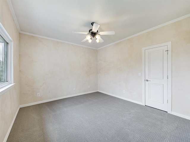 spare room featuring baseboards, ornamental molding, a ceiling fan, and carpet flooring