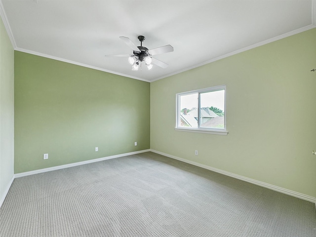 empty room featuring baseboards, ornamental molding, and ceiling fan
