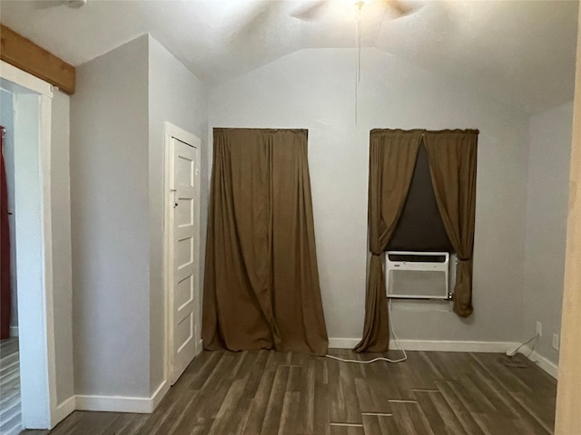 interior space featuring baseboards, dark wood-style floors, lofted ceiling, and cooling unit