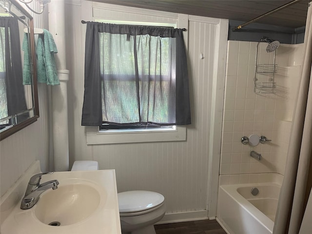 bathroom featuring vanity, toilet, shower / tub combination, and a wealth of natural light