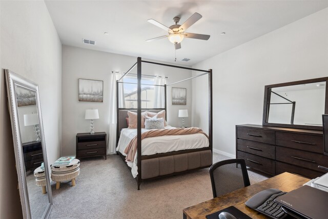 bedroom featuring visible vents, a ceiling fan, baseboards, and light carpet