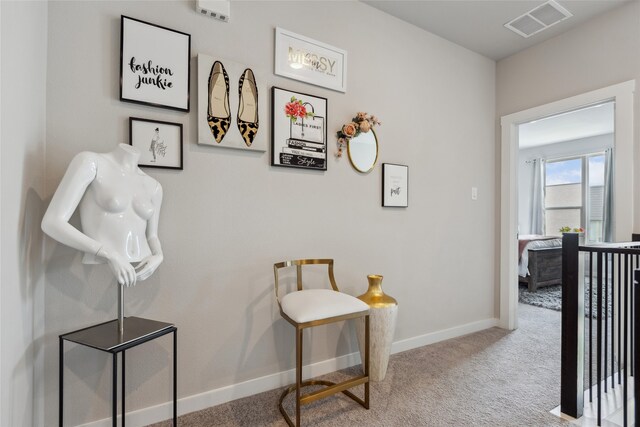 hall with baseboards, carpet, and visible vents