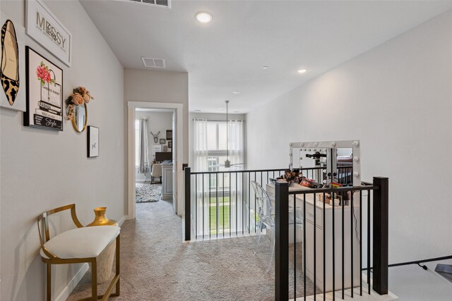 hall with carpet floors, recessed lighting, baseboards, an upstairs landing, and visible vents