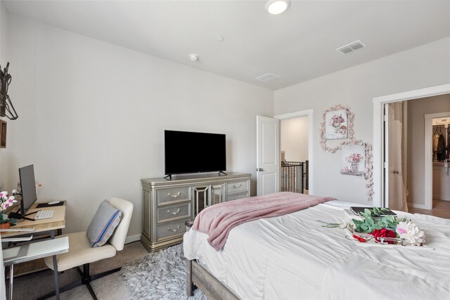 carpeted bedroom featuring baseboards and visible vents