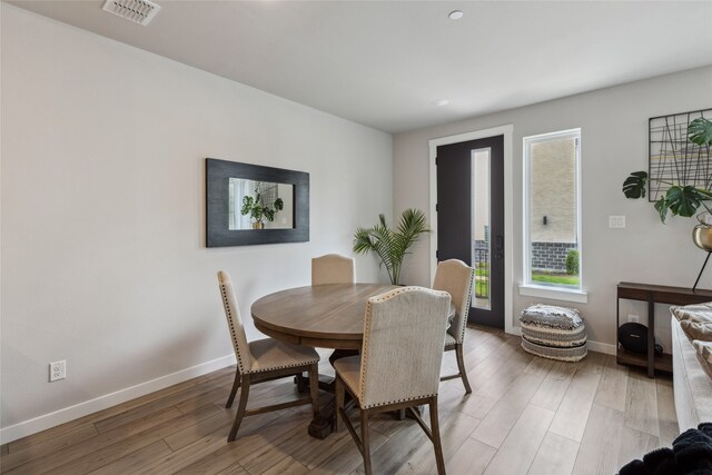 dining area with recessed lighting, baseboards, light wood-type flooring, and visible vents