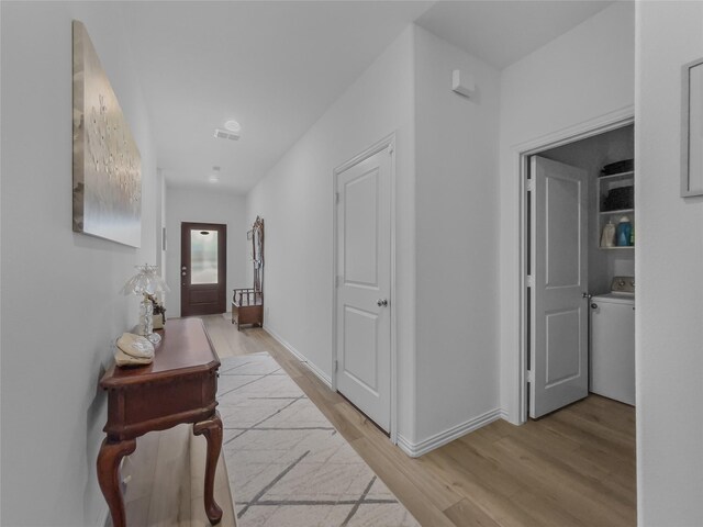 1151 Rumble Ln, Fate, TX 75087 - hall featuring washer / dryer, baseboards, light wood-style floors, and visible vents