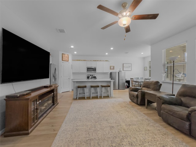 1151 Rumble Ln, Fate, TX 75087 - living area featuring recessed lighting, a ceiling fan, light wood finished floors, and visible vents