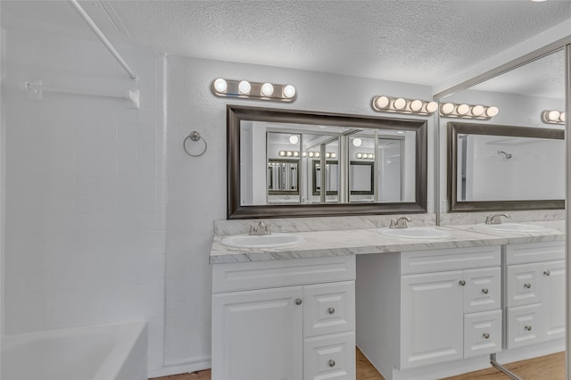 6040 Stoneybrook Dr, Fort Worth, TX 76112 - full bath featuring a sink, double vanity, and a textured ceiling