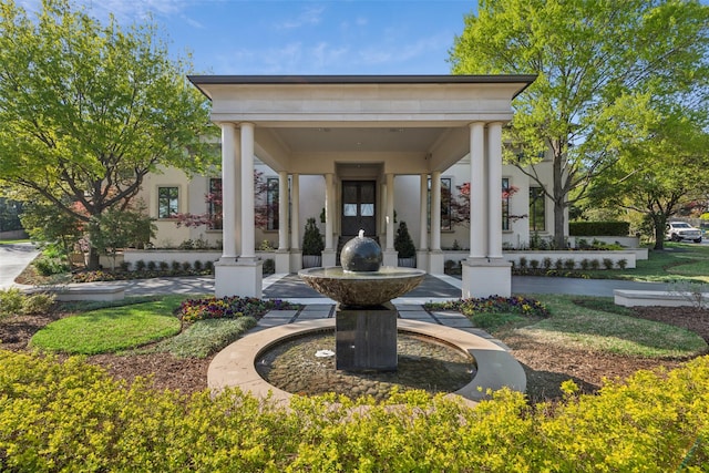 view of exterior entry featuring stucco siding