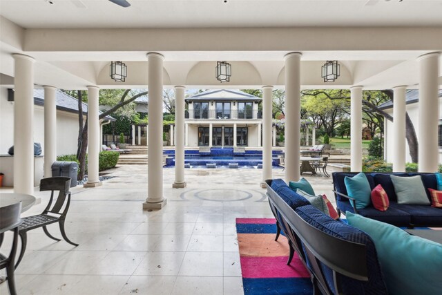 exterior space featuring an outdoor living space, ceiling fan, and a swimming pool