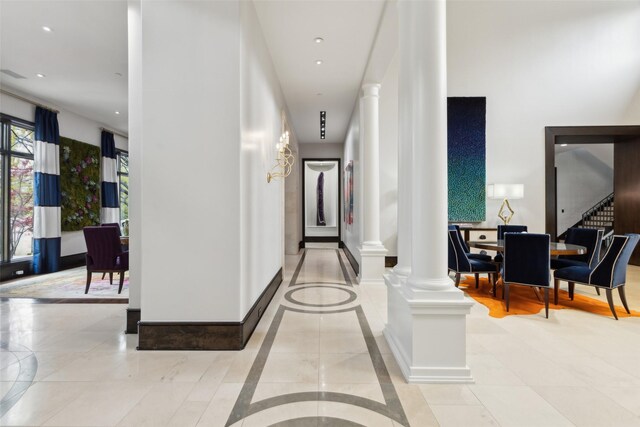 hallway with recessed lighting, ornate columns, and stairs
