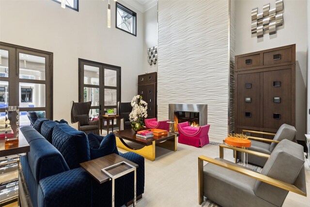 carpeted living room with plenty of natural light, french doors, and a towering ceiling