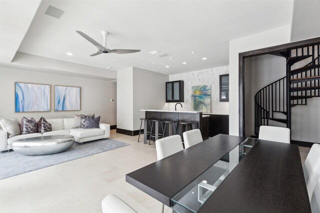 dining area with recessed lighting, baseboards, ceiling fan, and stairway