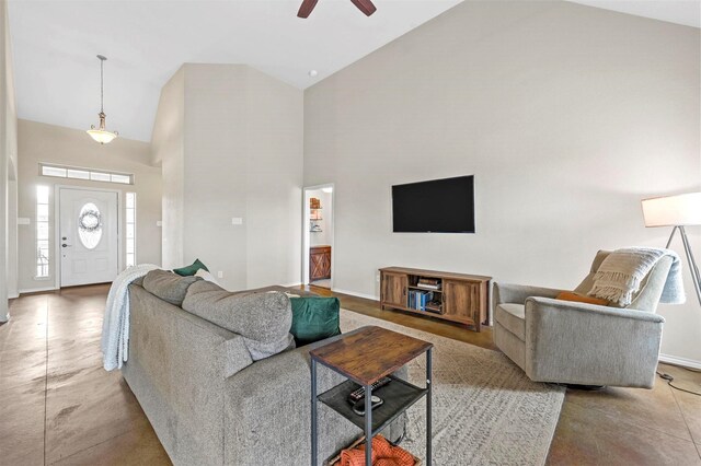 living room featuring baseboards, a ceiling fan, high vaulted ceiling, and a healthy amount of sunlight