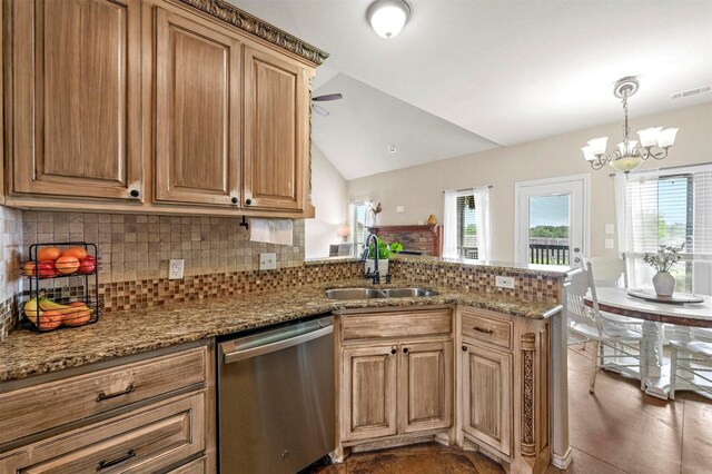 kitchen featuring visible vents, a peninsula, lofted ceiling, a sink, and dishwasher