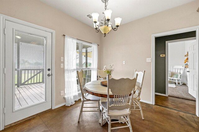 dining room with an inviting chandelier, baseboards, and visible vents