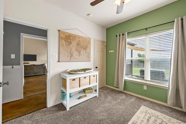 recreation room featuring baseboards, ceiling fan, and carpet flooring