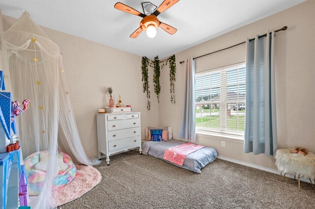 carpeted bedroom with baseboards and a ceiling fan