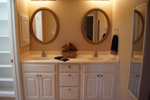 full bathroom with double vanity and a sink