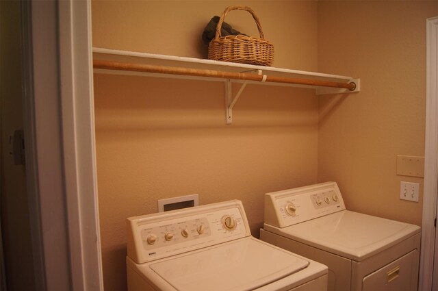 washroom featuring laundry area and washing machine and clothes dryer