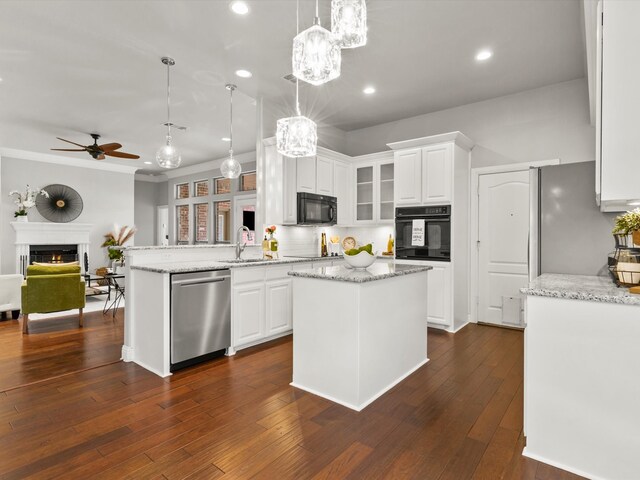 kitchen with a sink, a peninsula, white cabinets, a ceiling fan, and black appliances