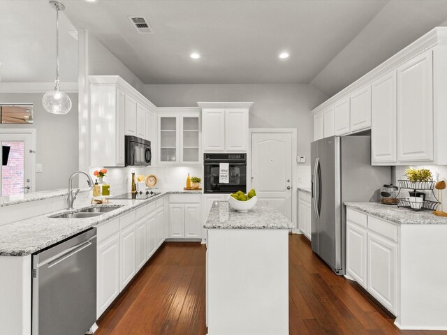kitchen with white cabinetry, dark wood finished floors, a sink, and black appliances