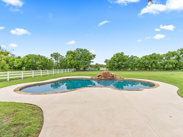 view of swimming pool with a fenced in pool, fence, a yard, and a patio area